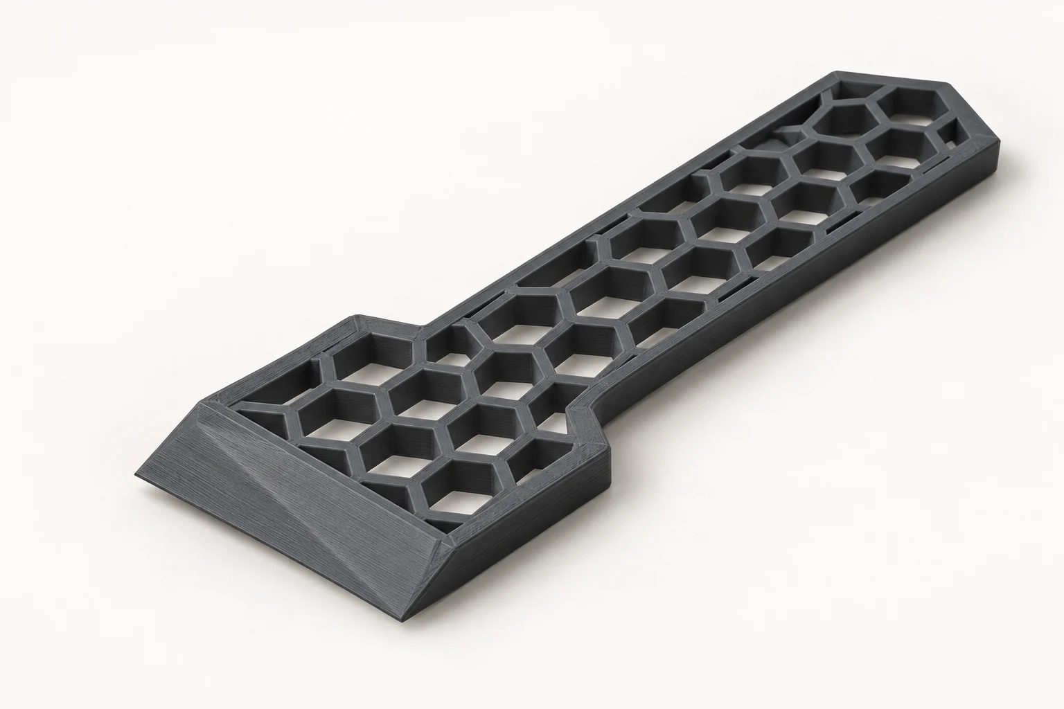 Model-based studio visualization of hex Handle Utility Scraper in charcoal-gray printed plastic.