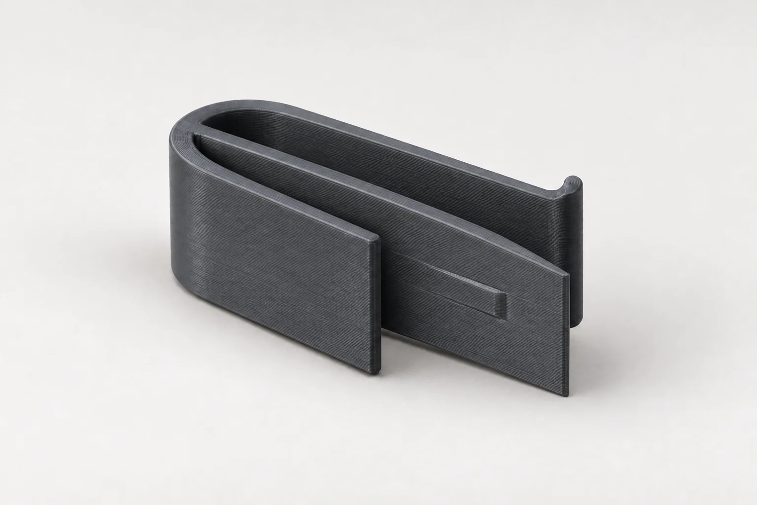 Model-based studio visualization of the standard-length Tesla air freshener clip in charcoal-gray printed plastic.
