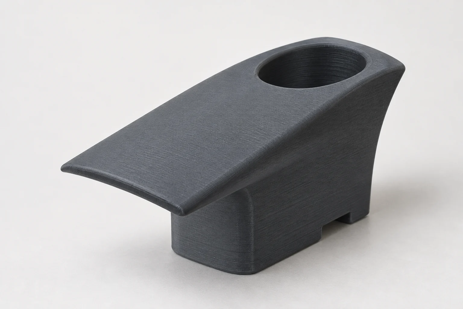 Model-based studio visualization of cable Organizer for Tesla Charging Equipment in charcoal-gray printed plastic.