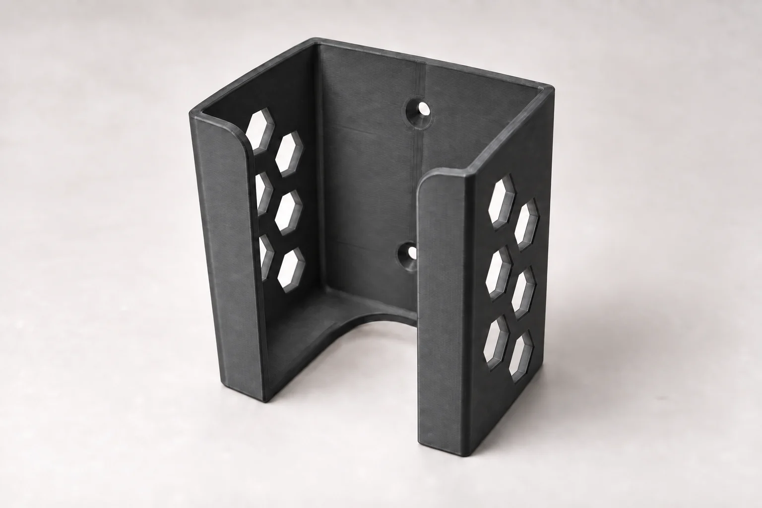 Model-based studio visualization of mobile Charger Holder for Tesla in charcoal-gray printed plastic.