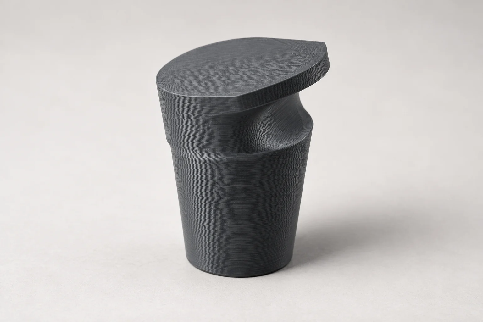 Model-based studio visualization of frunk Bag Hook for Tesla Model 3 in charcoal-gray printed plastic.